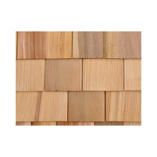 Close-up of natural cedar sidewall shingles with staggered courses, showing varied grain and color tones from honey to light brown.